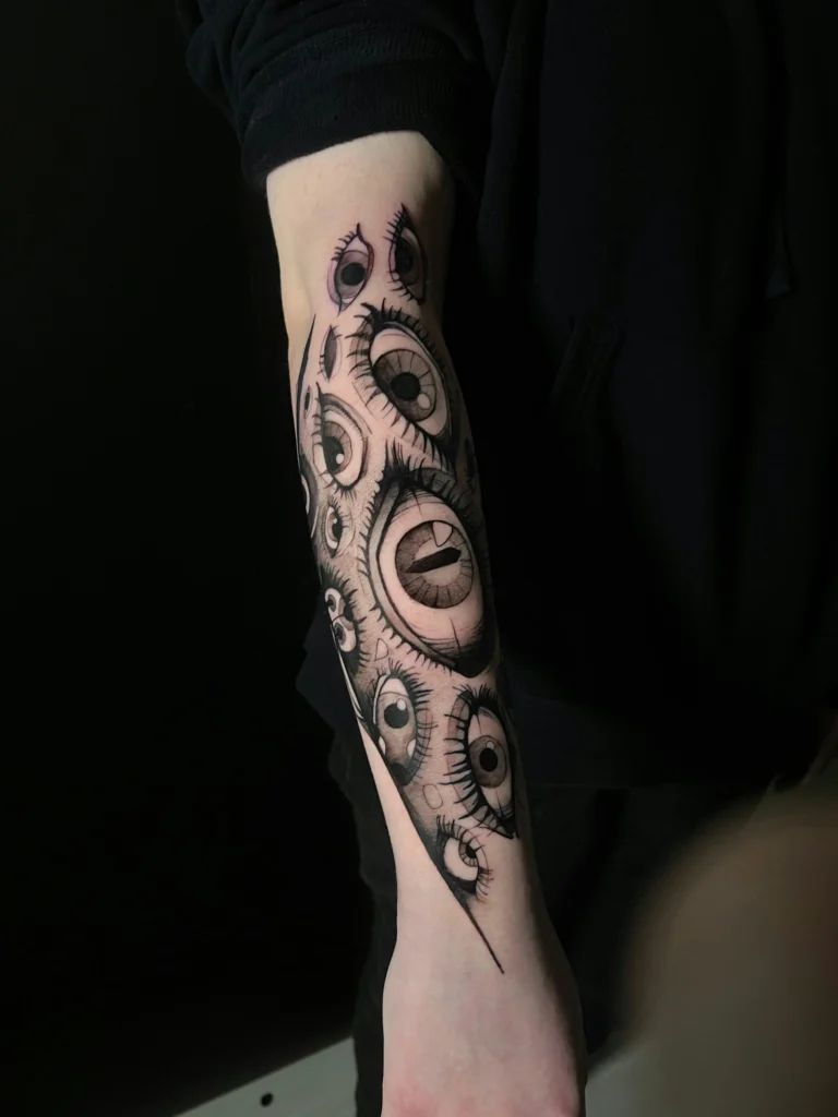 Blackwork eyes running down a forearm