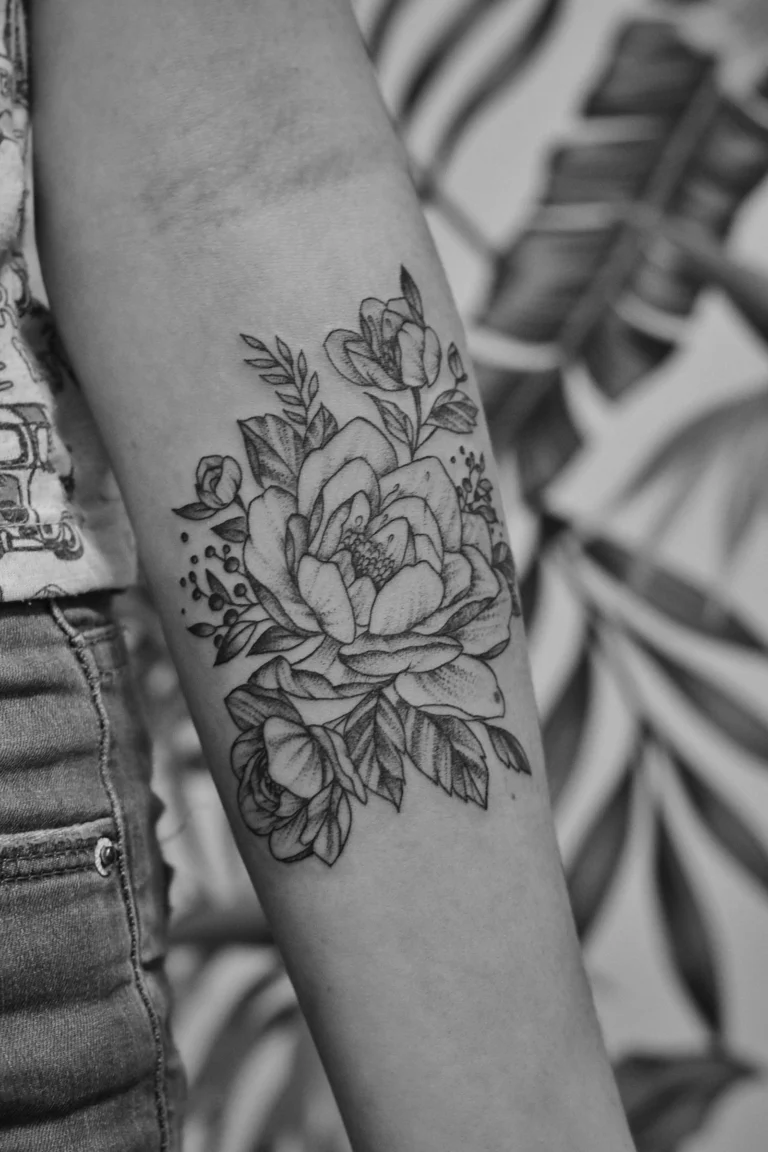 Fine line peony on a forearm
