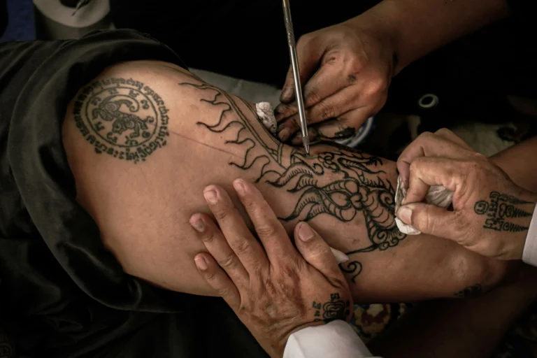Ornamental mandala being tattooed on a leg