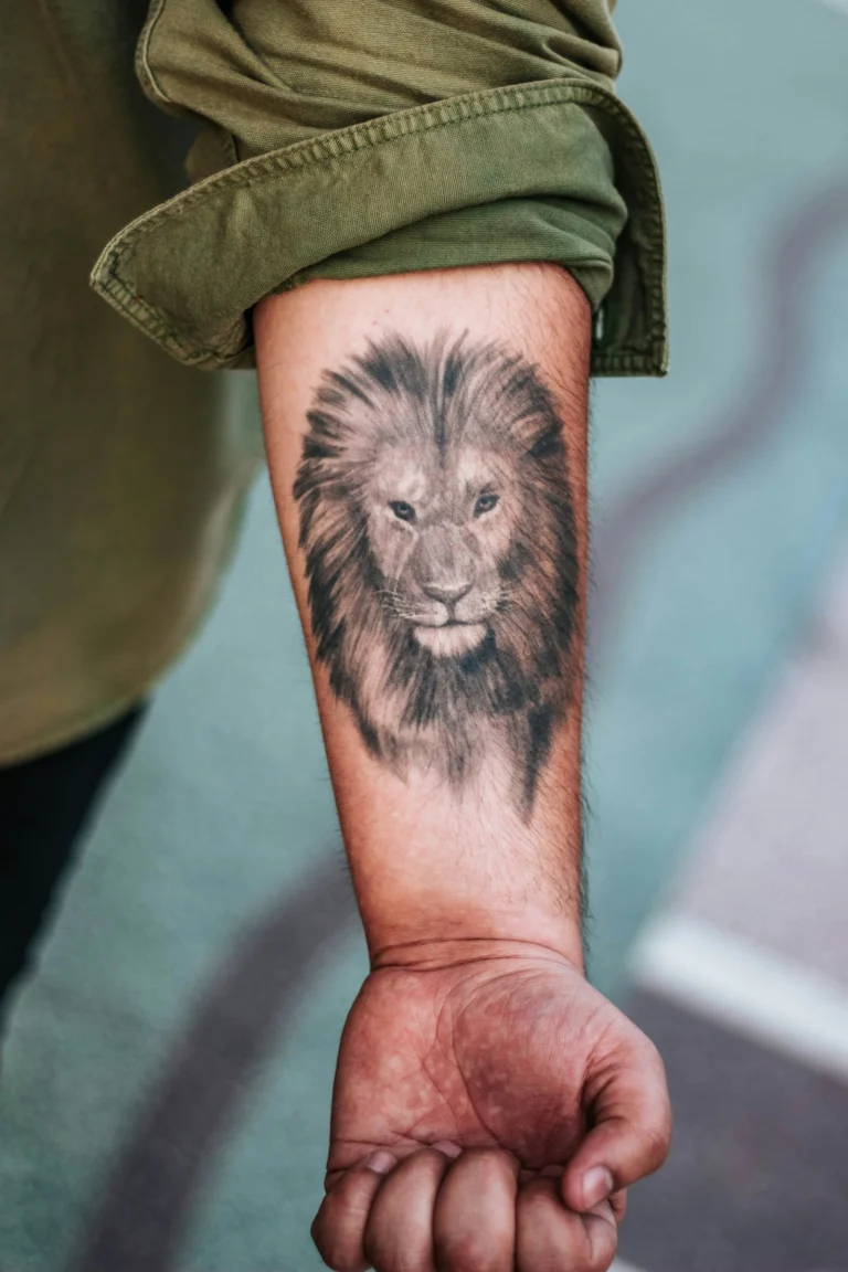 Black and grey lion on a forearm
