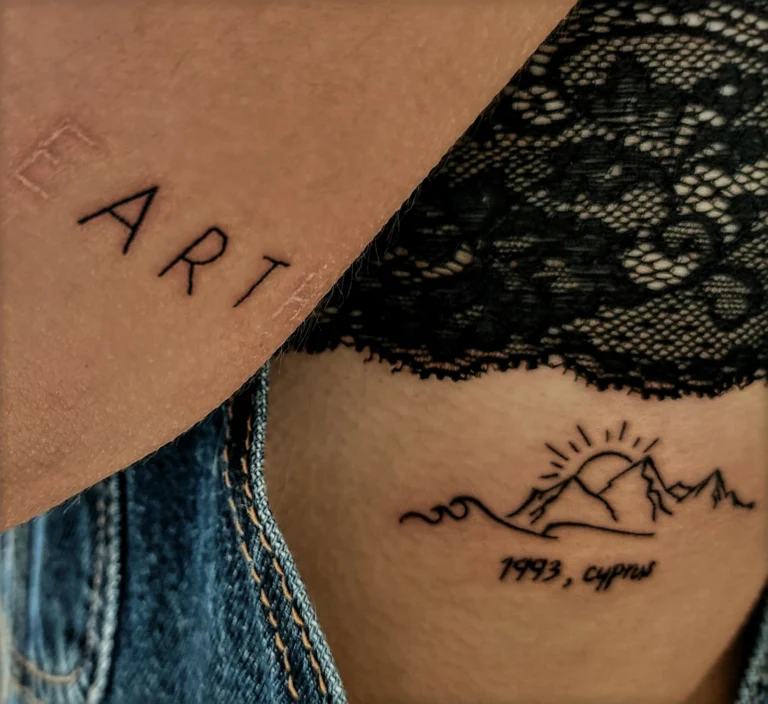 Hand-lettered words and a small landscape on the hip