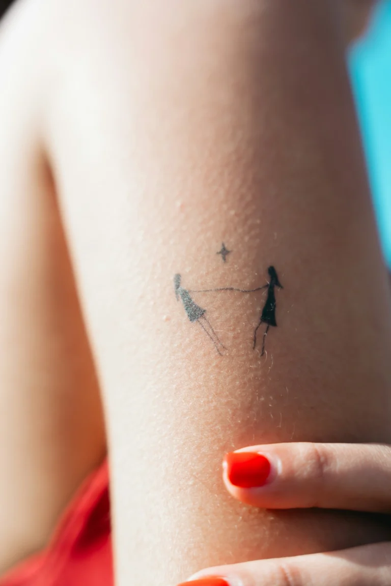 Minimal figures holding hands on the arm