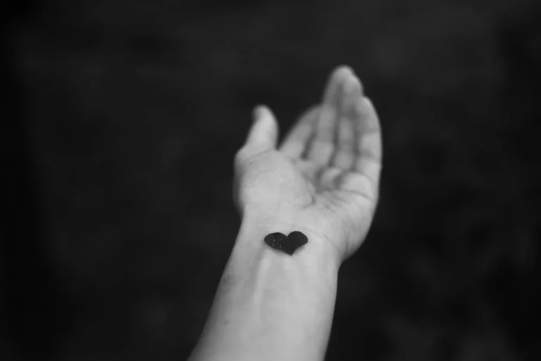A small black heart on the wrist