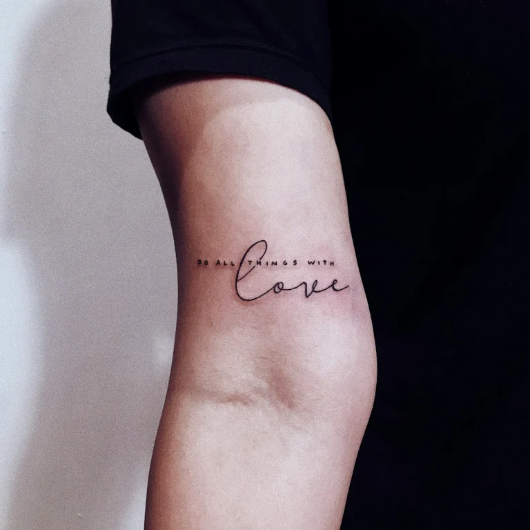 Delicate script tattoo on the back of an arm